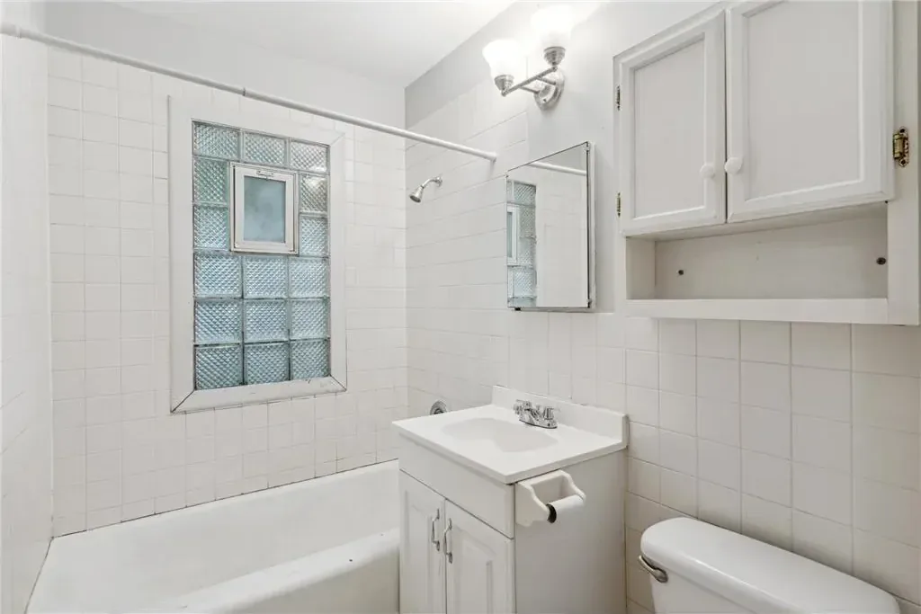 Repainted duplex bathroom in Northeast Minneapolis with crisp white walls and trim