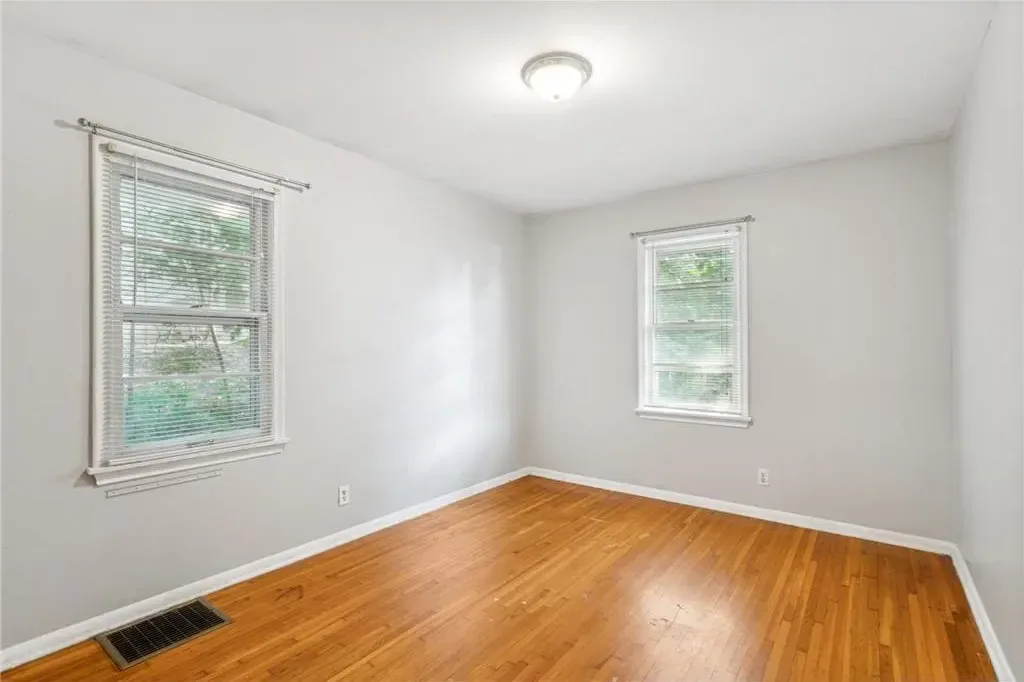 Freshly painted bedroom with light grey walls and white trim in a Northeast Minneapolis duplex