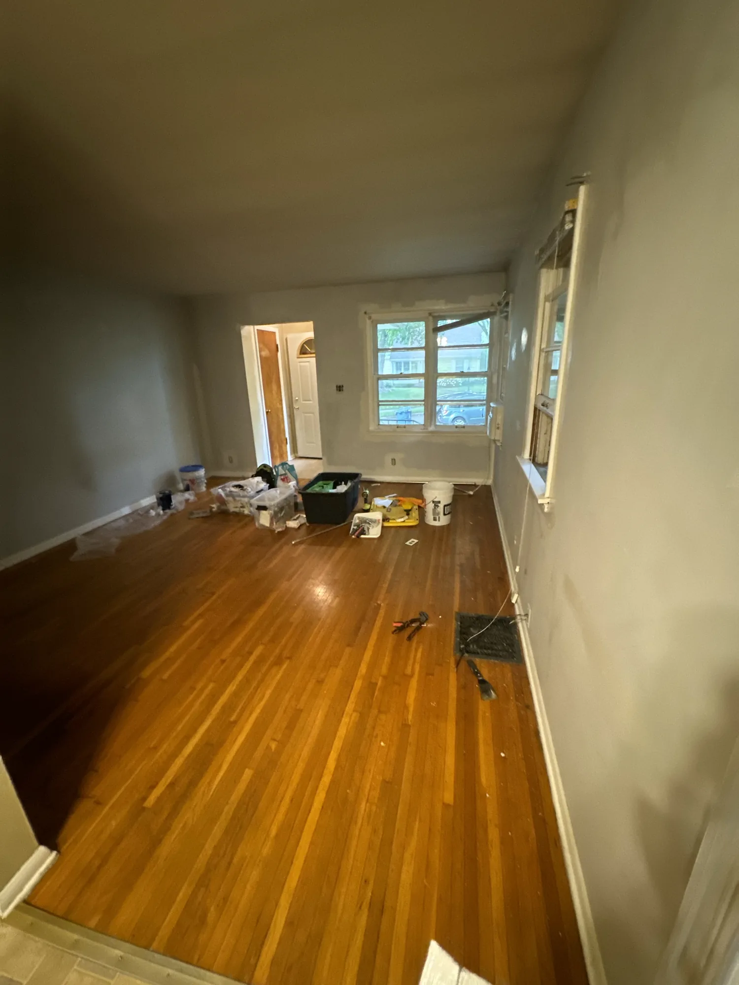 Living room with dark stained wood paneling before repainting, in a Northeast Minneapolis duplex