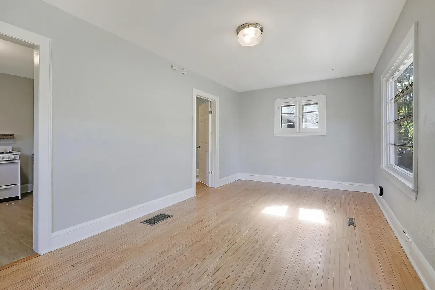 Another view of the freshly painted living room with a large picture window
